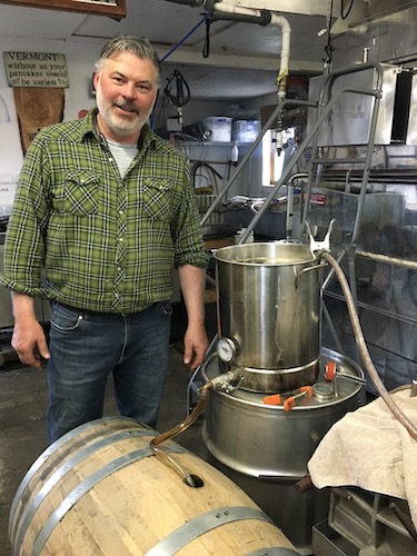 Al Wood pouring maple syrup into a Mad River Distillers barrel