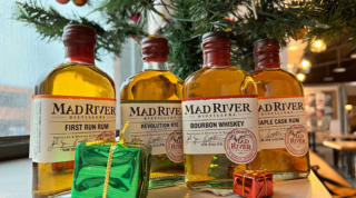Bottles of Mad River spirits under a Christmas tree
