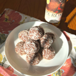 PX Rum Balls on a plate with a bottle of PX Rum behind it