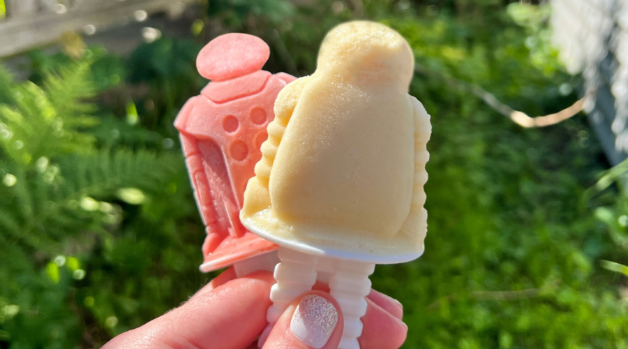 hand holding two rum popsicles