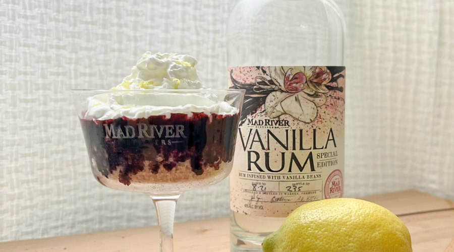 Blueberry Coupe Pie in a coupe next to a bottle of Mad River Distillers Vanilla Rum