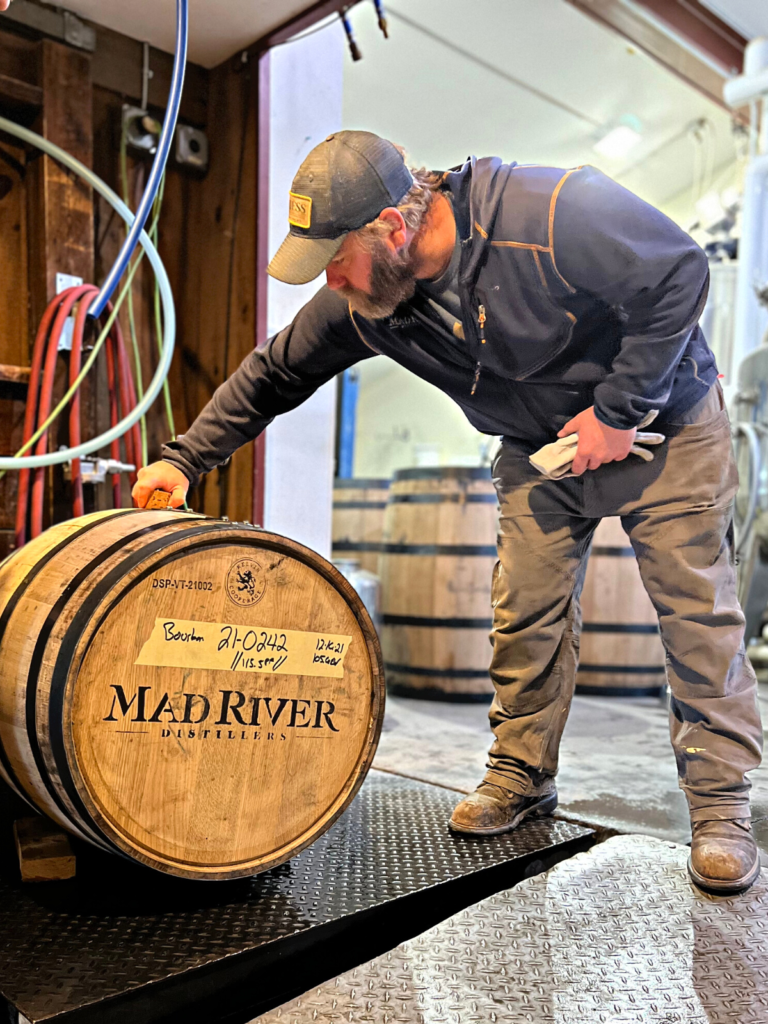 Man working on a barrel at the distillery