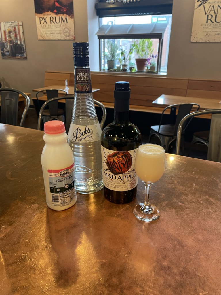 Brandy Alexander cocktail and ingredients on a table
