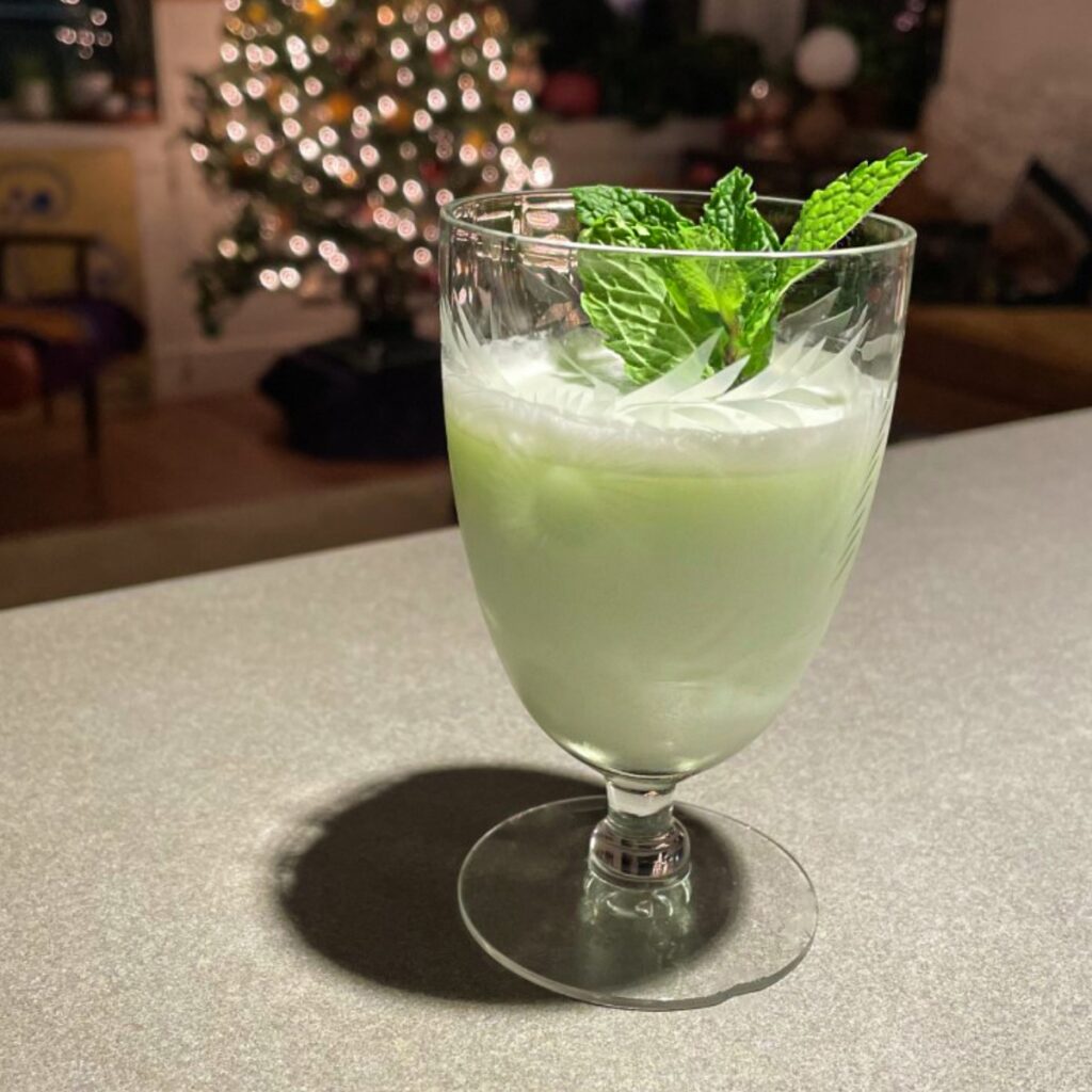 Mad River Grasshopper on a table with a sprig of mint