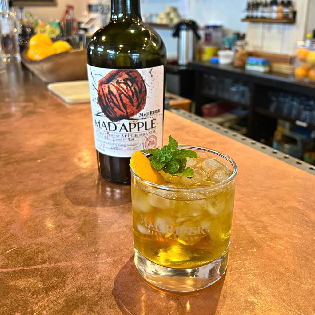 Mad River Stinger on the tasting room bar with a bottle of Mad Apple Brandy