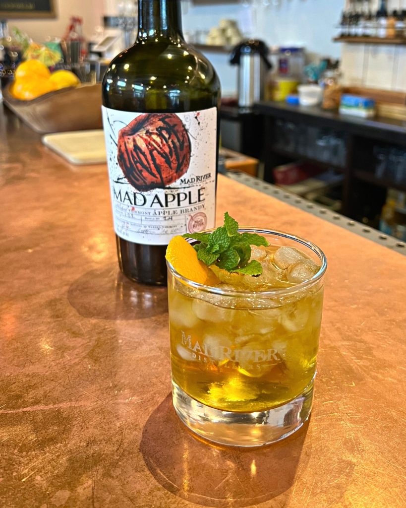 Mad River Stinger on the tasting room bar with a bottle of Mad Apple Brandy